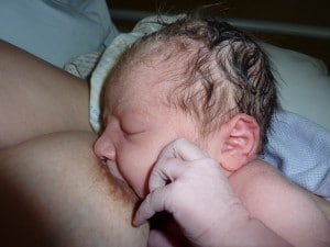 Close up of newborn baby latched on