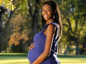 Smiling pregnant woman, photo courtesy of Kimberley Seals Allers
