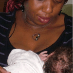 woman breastfeeds her baby