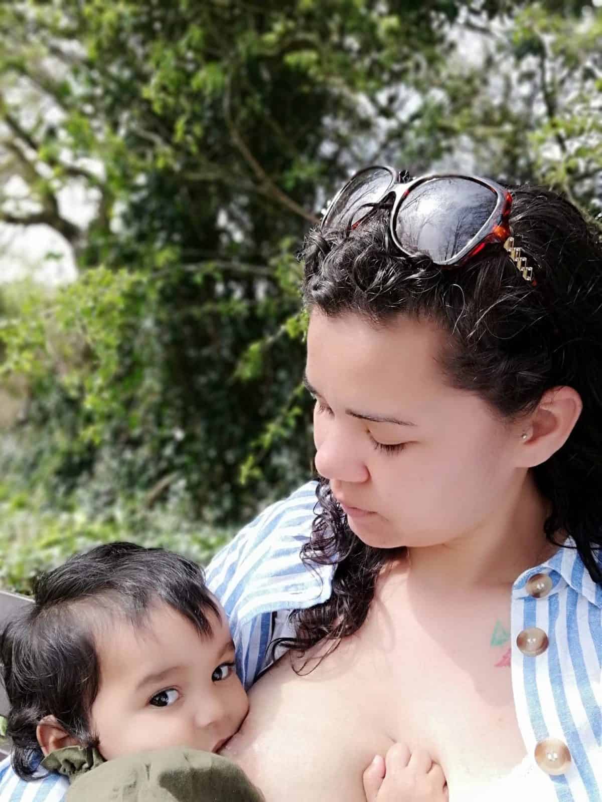 Mother looking at her nursing toddler